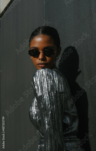 Portrait of beautiful African American woman posing on dark background. 