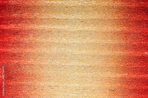 Texture of metallic crepe paper in red, orange and gold color gradient