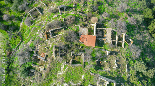 Ruins of traditional stone houses, rural depopulation in Cyprus. Aerial view directly above