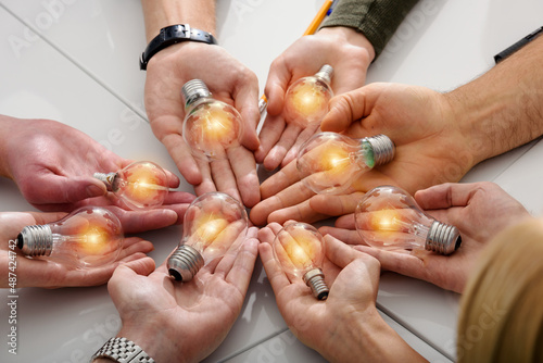 Teamwork and brainstorming concept with businessmen that share an idea with a lamp