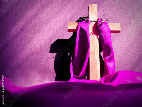 Lent Season,Holy Week and Good Friday concepts - image of wooden cross in purple vintage background. Stock photo. 