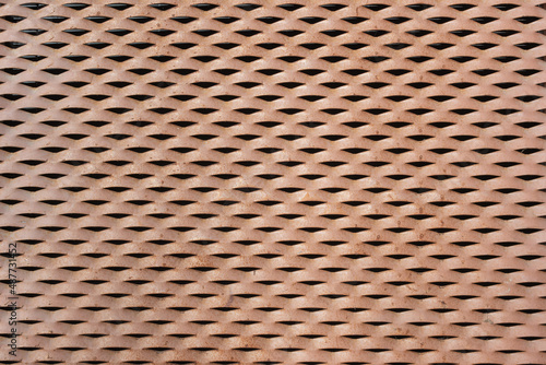 Fondo y textura de rejilla metálica oxidada en una pared