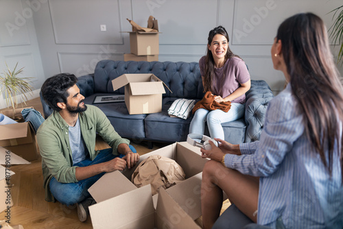 Friend help friend to unpack in her new apartment.