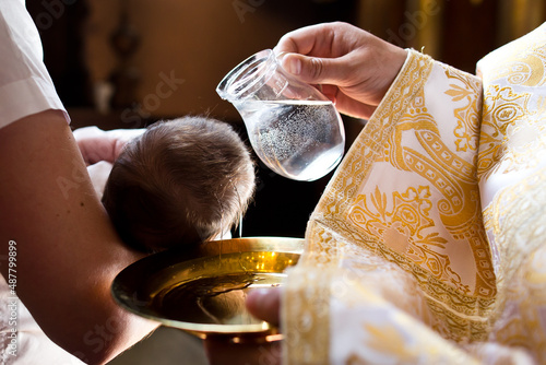 Infant baptism. Water is poured on the head of an infant.