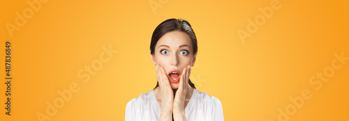 Wow! Excited surprised, astonished or very happy woman. Brunette girl with wide opened eyes, open mouth and raised hands. Unbelievable big sales, rebates offers, discounts deals concept studio image.