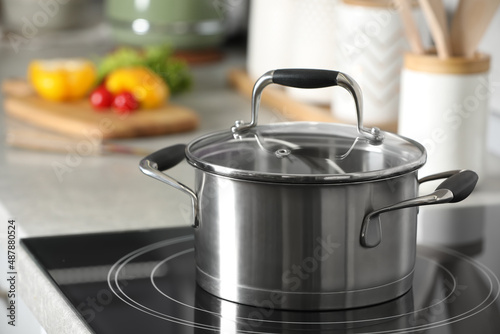 New shiny pot with glass lid in kitchen