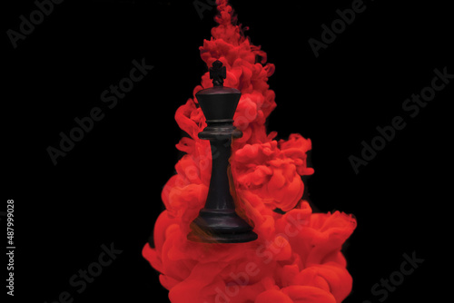  chess king floating in red ink 