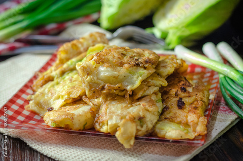 Cabbage fried in batter on a plate.