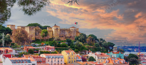 Panorama of the Lisbon city and Castelo de Sao Jorge, known as the Saint George historical castle, at sunset