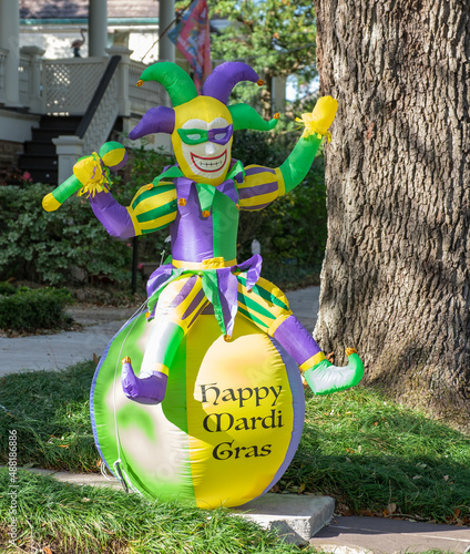Jester riding a beach ball Mardi Gras lawn decoration in Uptown neighborhood on February 18, 2022 in New Orleans, LA, USA