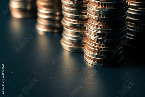 Pile of gold coins money stack in finance treasury deposit bank account saving . Concept of corporate business economy and financial growth by investment in valuable asset to gain cash revenue .