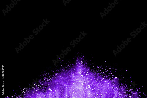 Purple powder explosion isolated on black background.