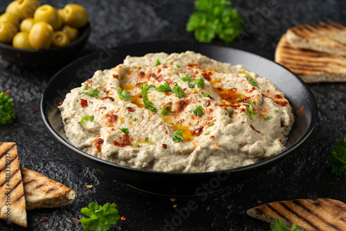 Baba ganoush dip made with grilled aubergine or eggplant, lemon juice, olive oil and tahini. Vegetarian starter food