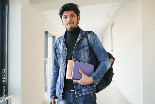 Happy indian male student at the university