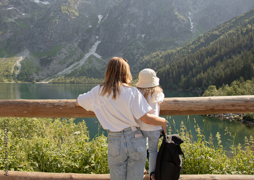 Mother with daughter near the Eye of the Sea lake (Morskie Oko) in Tatra mountain, Poland. Family, travel.