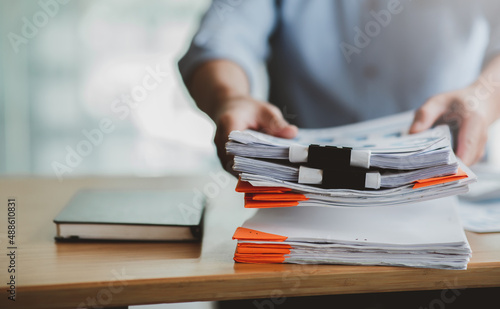 Business Documents, Auditor businesswoman checking searching document legal prepare paperwork or report for analysis TAX time,accountant Documents data contract partner deal in workplace office