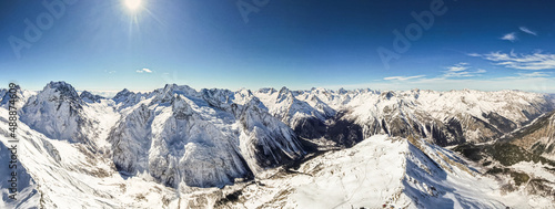 Beautiful panorama of mountain peaks on a sunny day photo from a drone 