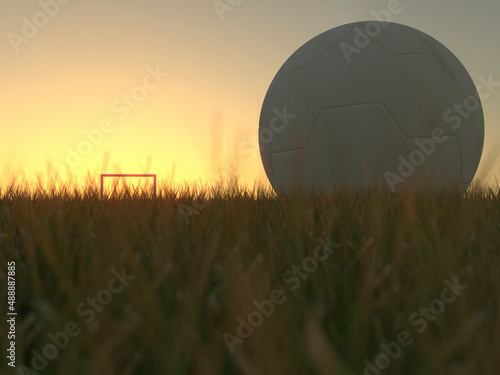 Uma bola de futebol sobre o gramado de um campo