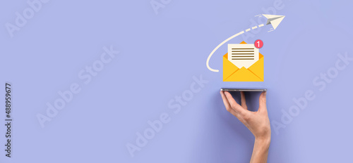 Businessman hand holding letter icon,email icons.Contact us by newsletter email and protect your personal information from spam mail.Customer service call center contact us.Email marketing newsletter.