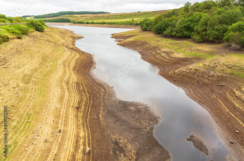 Leighton Reservoir in Nidderdale, North Yorkshire, UK, with very low water levels following a prolonged heatwave and no rainfall. Horizontal. Copy space.