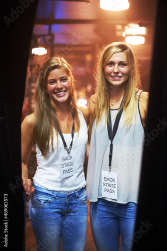 Two young women with backstage passes at a concert. This concert was created for the sole purpose of this photo shoot, featuring 300 models and 3 live bands. All people in this shoot are model