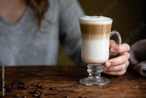 Irish coffee with hand holding the glass mug