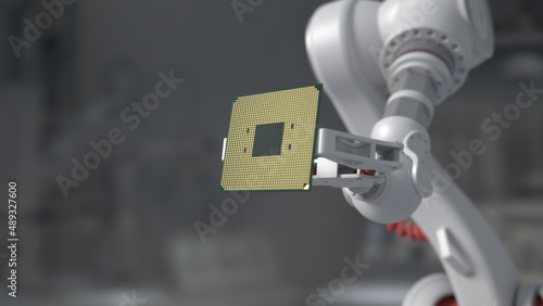 The robot holds a productive processor for a personal computer. Blurry gray background. The concept of future technologies . semiconductors.