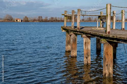 A wooden jetty on the Gherardesca lake, Lucca, Italy