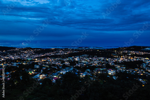 downtown city night view with lighting and dramatic cloudy sky at evening from mountain top