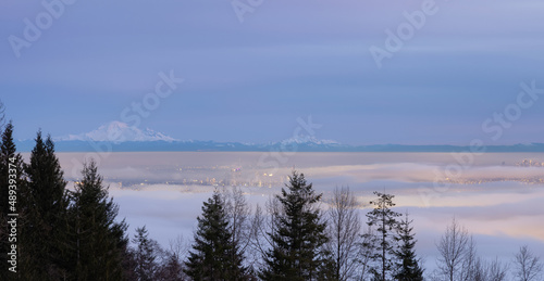 Fog Covering the Modern City during winter sunset twilight. Canadian Nature Background. Taken at Cypress Lookout, Vancouver, British Columbia, Canada.
