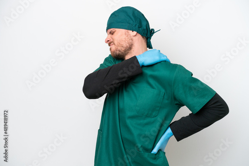 Surgeon Brazilian man in green uniform isolated on white background suffering from pain in shoulder for having made an effort