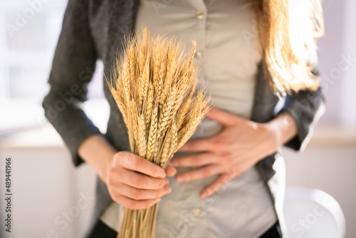 Celiac Disease And Gluten Intolerance. Women Holding Spikelet