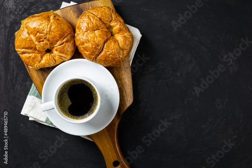 Breakfast / black coffee and croissants on the table / flat top view with copy space for your text.