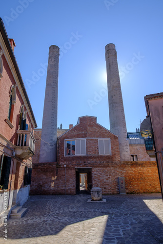 smokestack of an old factory in murano, venice, italy