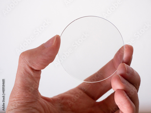 hand holds one glass lens