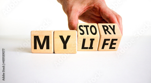 Story of my life symbol. Businessman turns wooden cubes and changes concept words My story to My life. Beautiful white table white background. Business story of my life concept. Copy space.