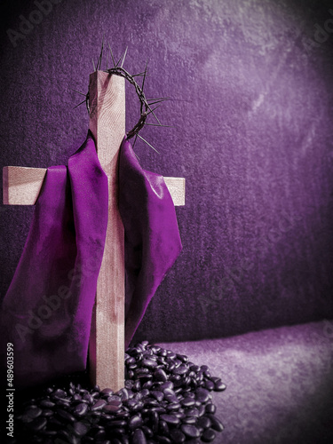 Lent Season,Holy Week and Good Friday concepts - image of wooden cross in purple vintage background. Stock photo. 