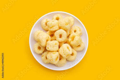 Roller corn snack on yellow background.