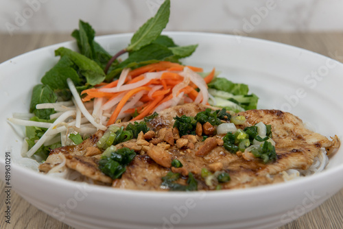 Delicious grilled chicken for a Vietnamese meal served with vermicelli in a bowl