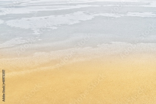 Frozen lake (background) - resembling waves on a sandy beach