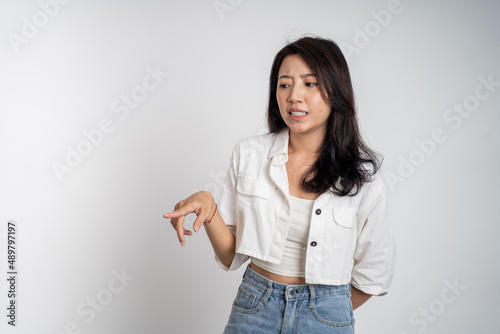 asian woman feeling disgusted and pointing at something