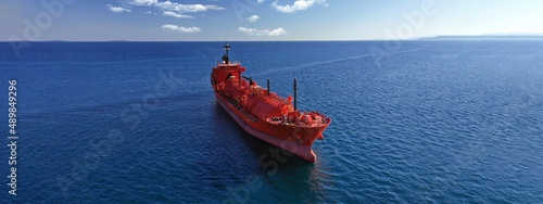 Aerial drone ultra wide top down photo of industrial LPG gas tanker ship anchored in deep blue sea