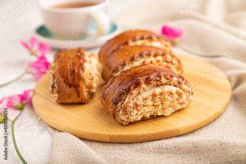 Traditional armenian dessert gata with cup of green tea on a gray concrete background. side view, close up, selective focus.