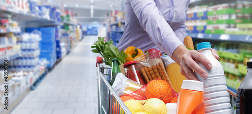 Woman doing grocery shopping at the supermarket