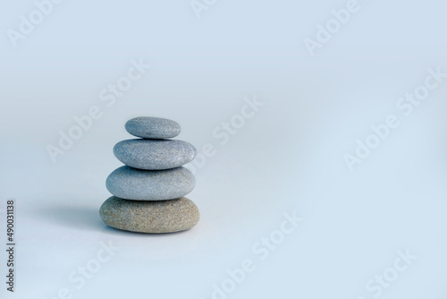 Tower, stack of pebbles in an unstable state, pyramid made of flat stones on a gray background, concept tourist walk in nature, harmony and balance, zen in life, nature conservation