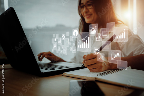 Businesswoman using laptop in data management. 