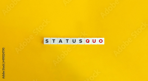 Status Quo Latin Phrase on Letter Tiles on Yellow Background. Minimal Aesthetics.