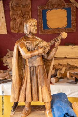 wood carving depicting a minstrel playing his lute