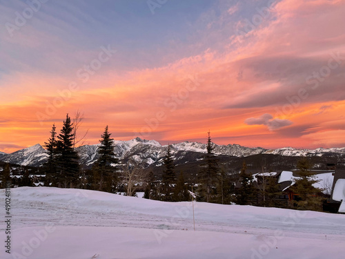Dramatic and colourful sunset skies over Gallatin Peak as seen from Big Sky, Montana on a winter day