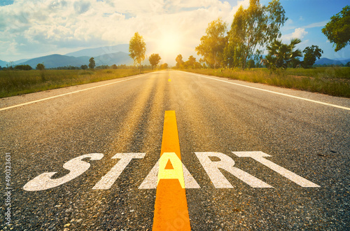 Start written on the asphalt road sunset.Concept of challenge or career path and change.